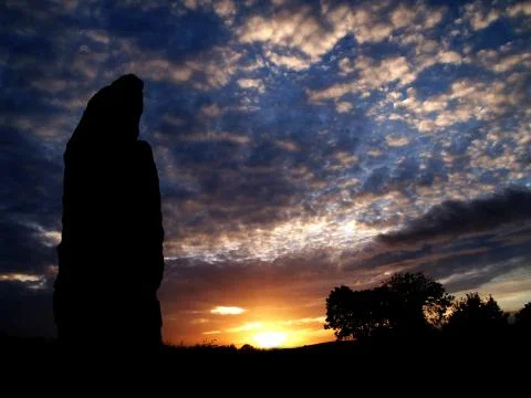 Standing stone in the sunset Stock Photos