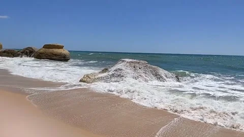 Standing strong as a rock in the surf Video stock 153332437