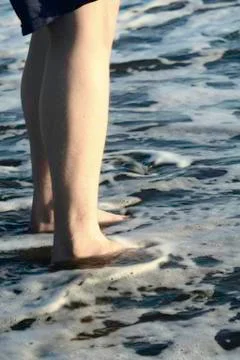 Standing in the surf Stock Photos