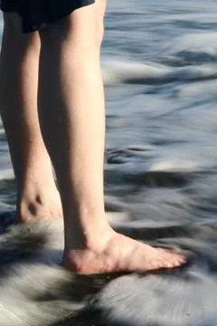 Standing in the surf 写真素材