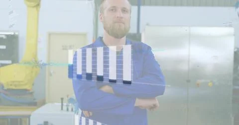 Standing tech wearing blue coverall crossing arms on factory floor, with AR Stock Photos