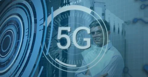 Standing telecom engineer crossing arms in data center with racks, cables and 5G Stock Photos