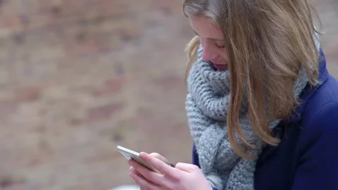 Standing Texts: Blonde Engaging in Park Messaging Stock Footage 266304821