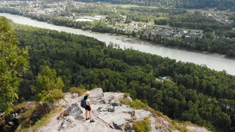 Standing on the top of mountain, rock alone. Finish of the hiking track. Video stock 140033566