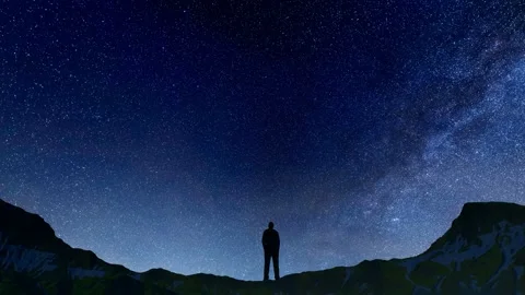 Standing on the top of the snow-capped mountains and looking up at the stars Stock Footage 288272726