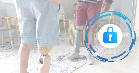 Standing two men adjusting prosthetic limbs at rehab clinic lounge, wearing Stock Photos