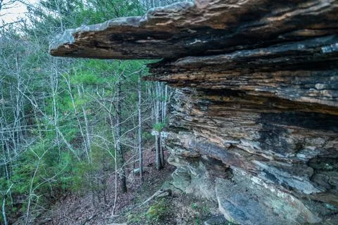 Standing under a cliff Stock Photos