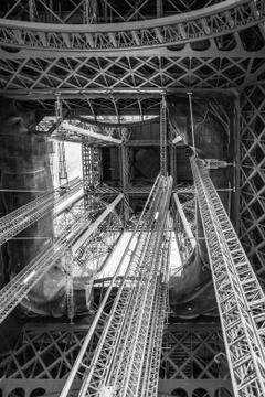 Standing under Eiffel Tower Tour Eiffel blue sky clouds black and white Stock Photos