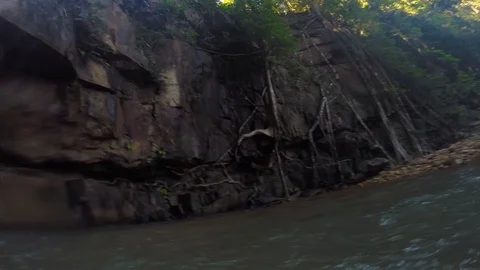 Standing under a waterfall with a local guide in Cambodia, Kampot Stock Footage 100786144