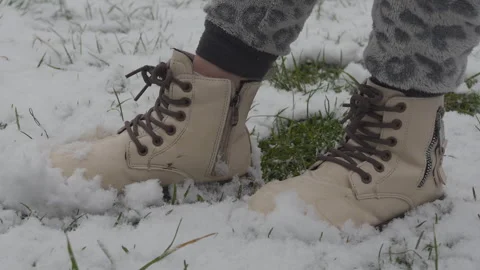 Standing in white boots on the snow in spring Video stock 304052930