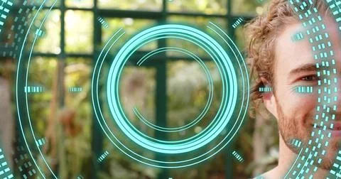 Standing white man facing camera at home by grid window, showing turquoise HUD Stock Photos