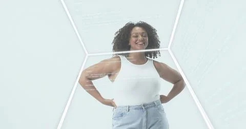 Standing woman posing in studio cube white tanktop light-blue jeans with cyan Stock Photos