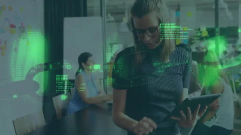 Standing woman scrolling tablet in tech office spawning code overlay, comparing Stock Footage 312229483