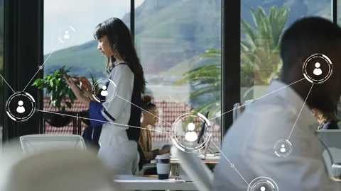 Standing woman tapping smartphone, creating node overlay linking team laptops Stock Footage 333004933
