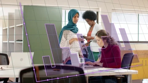 Standing woman tapping tablet causing chart overlay on PC seated typing third Stock Footage 333540070