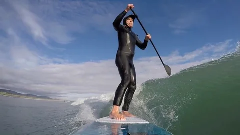 Standup paddle board surfer (SUP) surfing a wave, slow motion Stock Footage 77499360