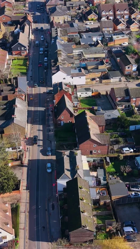 Stanstead Abbotts High Street vertical drone flyover tracking traffic toward Видео 331216876