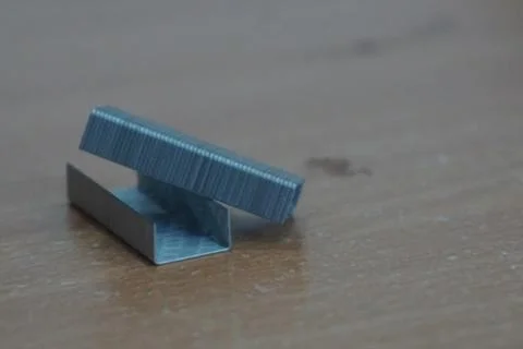 Staple that will be driven by stapler through sheets of paper to fasten them Foto stock