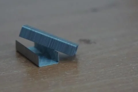 Staple that will be driven by stapler through sheets of paper to fasten them Foto stock