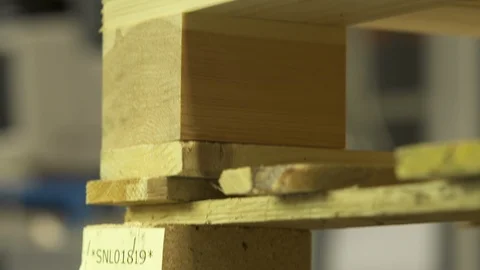 Stapled pallets with miniature models trying to lift pallet Stock Footage 102554632