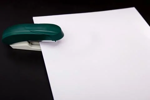 Stapler and a sheet of paper Stock Photos