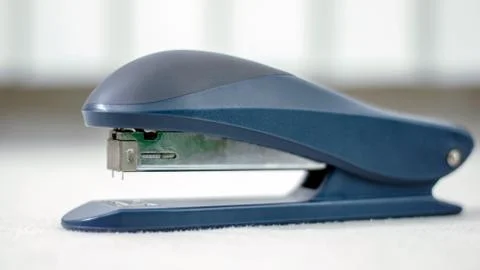 Stapler Close Up On White Desk. Stock Photos