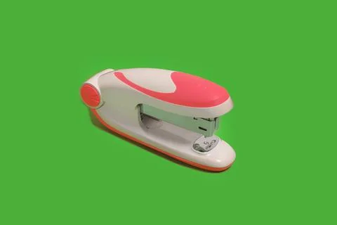 Stapler on a green background. school and office accessories Stock Photos