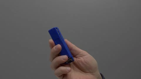 The stapler in the hand on a gray background. Stock Footage 265598239