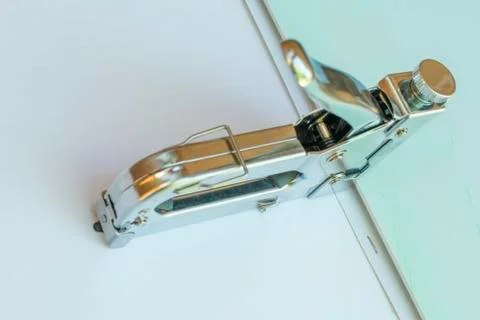 Stapler made of metal, for stapling panels in work. Stock Photos
