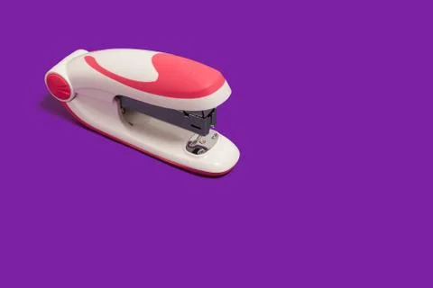 Stapler on a purple surface Stock Photos