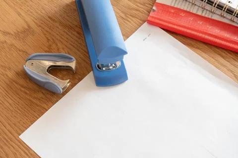 Stapler staple remover and white paper for office document preparation Stock Photos