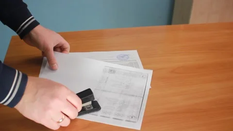 A Stapler Stapling Paper Stock Footage 149176098