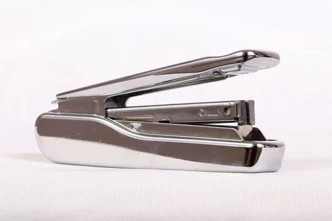 A stapler used to attach a bunch of papers Stock Photos