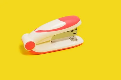 Stapler on a yellow background Stock Photos