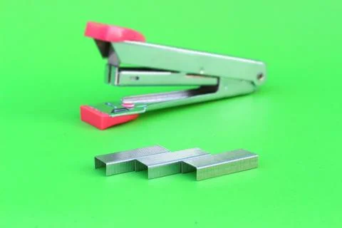 Staples on isolated green Stock Photos