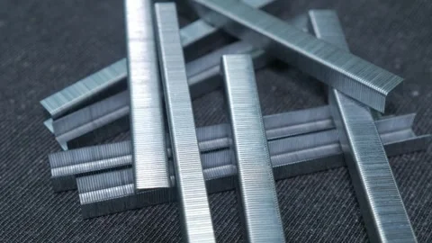 Staples for the pneumatic stapler rotate against the background Stock-Footage 243934351