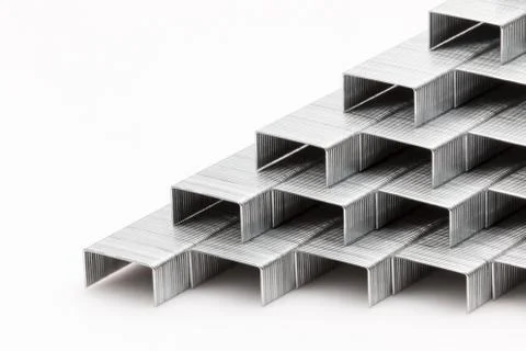Staples stacked up on a white background. Stock Photos
