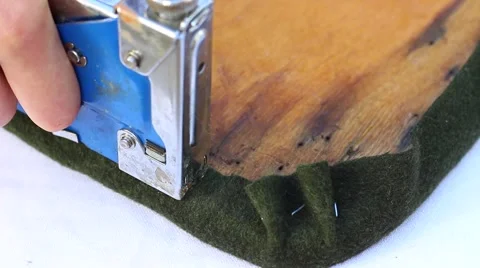 Stapling a fabric to chair piece Vídeo Stock 59987063