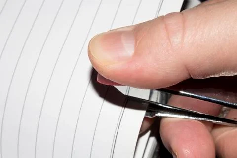 Stapling paper with staples.Stapler in the hand of man. 写真素材