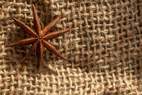The star of Anise lies on the burlap. Stock Photos