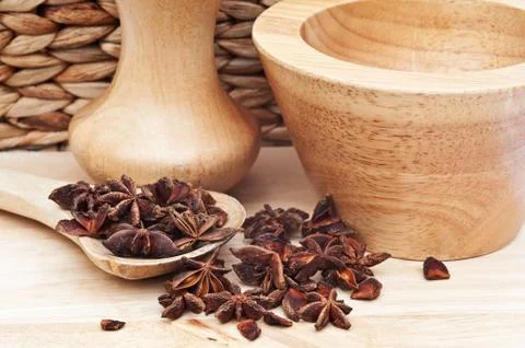 Star anise in rustic kitchen setting with wooden utensils Stock Photos
