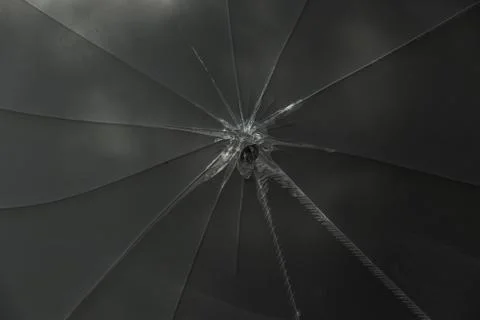 Star blast cracks in the glass panel. Broken glass texture. Deep realistic gl Stock Photos