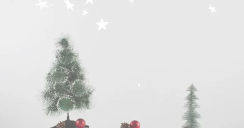 Star confetti falling, baubles dropping near tree, pinecones settling on slices Vídeos de archivo 318758663