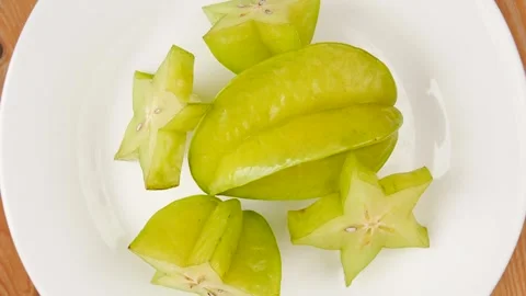 Star fruit on a plate. Video stock 245974565