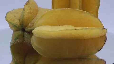 Star fruit on white background rotating Stock Footage 124693360