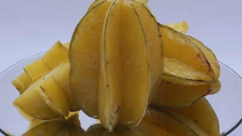 Star fruit on white background rotating Stock Footage 124693419