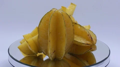 Star fruit on white background rotating Stock Footage 124693489