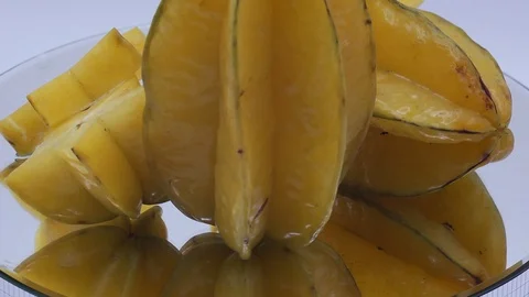 Star fruit on white background rotating Stock Footage 124693614