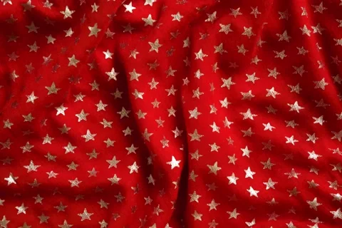 Star pattern on a red fabric stop motion background. Brightly colored crumple Stock Footage 162621038