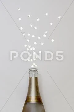 Star Shaped Confetti Spraying Out Of A Champagne Bottle